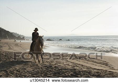 Woman riding a horse on the beach, Sayulita, Nayarit, Mexico View Large Photo Image Picture - Woman riding a horse on the beach, Sayulita, Nayarit, Mexico. Fotosearch