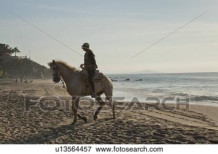 Woman riding a horse on the beach, Sayulita, Nayarit, Mexico View Large Photo Image Stock Photo - Woman riding a horse on the beach, Sayulita, Nayarit, Mexico. Fotosearch