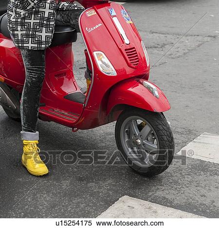 Woman riding a scooter waiting at a zebra crossing, St. Petersburg, Russia View Large Photo Image Stock Photography - Woman riding a scooter waiting at a zebra crossing, St. Petersburg, Russia. Fotosearch