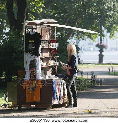 Stock Image - Woman shopping at a souvenir shop, St. Petersburg, Russia. Fotosearch
