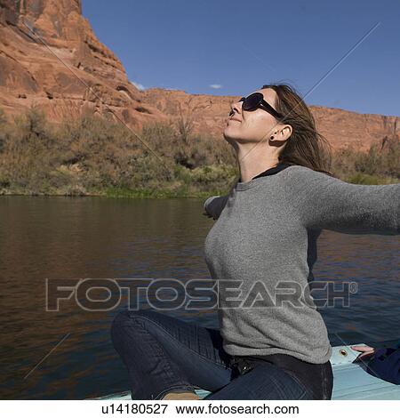 Woman sitting on a boat, Colorado River, Glen Canyon National Recreation Area, Arizona-Utah, USA View Large Photo Image Stock Photo - Woman sitting on a boat, Colorado River, Glen Canyon National Recreation Area, Arizona-Utah, USA. Fotosearch