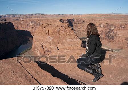 Woman sitting on a rock looking at a view, Horseshoe Bend, Glen Canyon National Recreation Area, Arizona-Utah, USA View Large Photo Image Stock Image - Woman sitting on a rock looking at a view, Horseshoe Bend, Glen Canyon National Recreation Area, Arizona-Utah, USA. Fotosearch