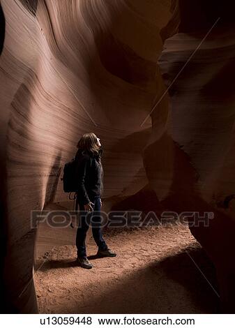 Stock Photo - Woman standing in a cave, Tse Bighanilini, Upper Antelope Canyon, Antelope Canyon, Page, Arizona, USA. Fotosearch