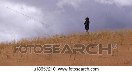 Woman standing in a desert, Coral Pink Sand Dunes State Park, Utah, USA View Large Photo Image Stock Image - Woman standing in a desert, Coral Pink Sand Dunes State Park, Utah, USA. Fotosearch