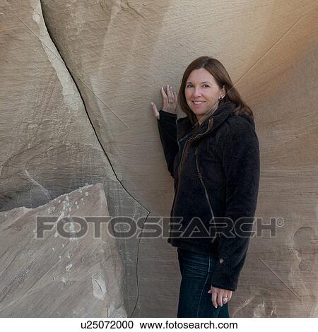 Woman standing near a cliff posing, Amangiri, Canyon Point, Hoodoo Trail, Arizona-Utah, USA View Large Photo Image Stock Image - Woman standing near a cliff posing, Amangiri, Canyon Point, Hoodoo Trail, Arizona-Utah, USA. Fotosearch