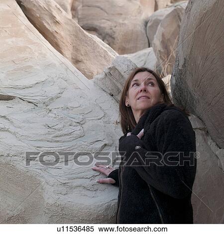 Woman standing near cliffs, Amangiri, Canyon Point, Hoodoo Trail, Arizona-Utah, USA View Large Photo Image Stock Photography - Woman standing near cliffs, Amangiri, Canyon Point, Hoodoo Trail, Arizona-Utah, USA. Fotosearch