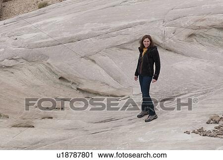 Stock Image - Woman standing on a rock, Amangiri, Canyon Point, Hoodoo Trail, Utah, USA. Fotosearch