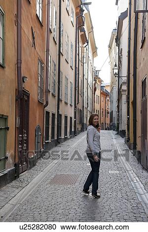 Woman standing on a street, Gamla Stan, Stockholm, Sweden View Large Photo Image Stock Image - Woman standing on a street, Gamla Stan, Stockholm, Sweden. Fotosearch