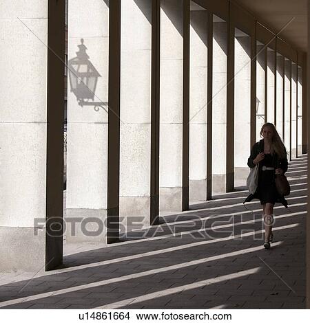 Woman walking in a corridor, Gamla Stan, Stockholm, Sweden View Large Photo Image Picture - Woman walking in a corridor, Gamla Stan, Stockholm, Sweden. Fotosearch