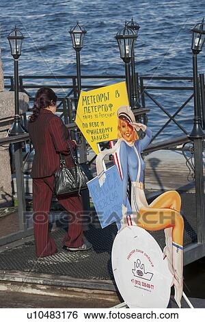 Woman walking on a footbridge near a sign, Neva River, St. Petersburg, Russia View Large Photo Image Stock Photograph - Woman walking on a footbridge near a sign, Neva River, St. Petersburg, Russia. Fotosearch
