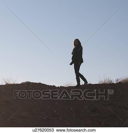Woman walking on rock, Utah, USA View Large Photo Image Stock Image - Woman walking on rock, Utah, USA. Fotosearch
