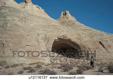 Woman walking towards Ulrike's Cave, Amangiri, Canyon Point, Utah, USA View Large Photo Image Stock Photo - Woman walking towards Ulrike's Cave, Amangiri, Canyon Point, Utah, USA. Fotosearch