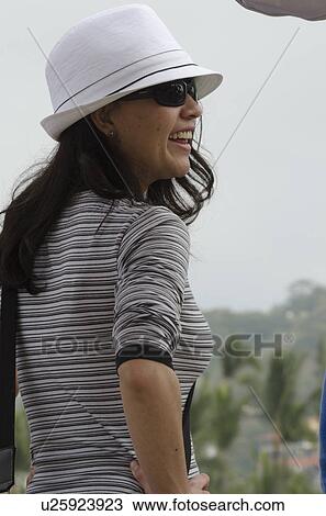 Stock Image - Woman wearing a hat and laughing, Sayulita, Nayarit, Mexico. Fotosearch