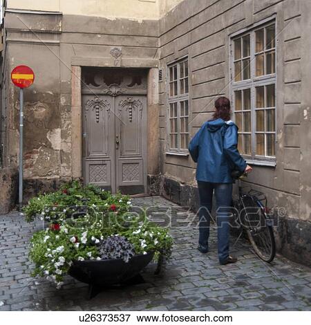 Woman with a bicycle in front of a house, Gamla Stan, Stockholm, Sweden View Large Photo Image Stock Photo - Woman with a bicycle in front of a house, Gamla Stan, Stockholm, Sweden. Fotosearch