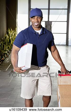African American man carrying boxes for delivery View Large Photo Image Stock Photo - African American man carrying boxes for delivery. Fotosearch