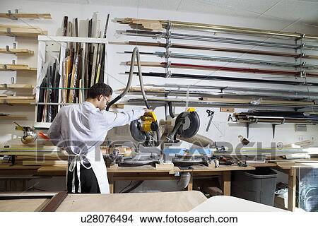 Back view of young man using circular saw in workshop View Large Photo Image Picture - Back view of young man using circular saw in workshop. Fotosearch