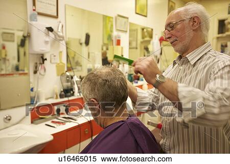 Barber cutting senior man's hair in barbershop View Large Photo Image Stock Photography - Barber cutting senior man's hair in barbershop. Fotosearch