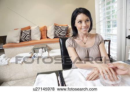 Beautiful happy woman getting herself pampered in beauty spa View Large Photo Image Stock Photo - Beautiful happy woman getting herself pampered in beauty spa. Fotosearch