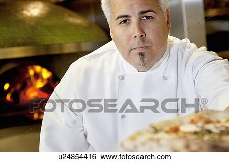 Close-up of a confident chef with pizza View Large Photo Image Stock Photograph - Close-up of a confident chef with pizza. Fotosearch