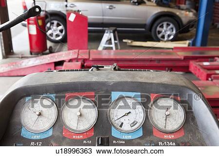 Stock Image - Close-up of a hoist pressure gauge in garage. Fotosearch