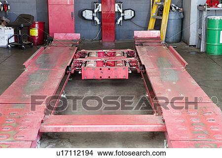 Picture - Close-up of empty hoist in repairing garage. Fotosearch