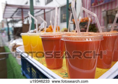Close-up of fruit juices on display at market stall View Large Photo Image Stock Image - Close-up of fruit juices on display at market stall. Fotosearch
