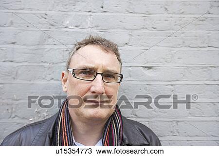 Stock Image - Close-up of mature man wearing glasses looking away. Fotosearch