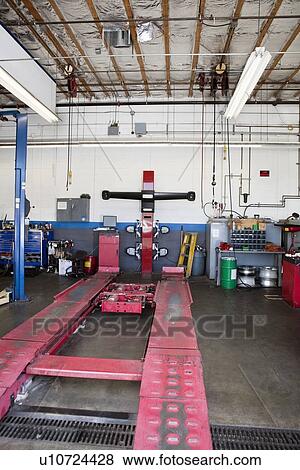 Stock Photo - Empty hoist in car workshop. Fotosearch
