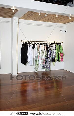 Stock Photo - Female clothes hanging on rack in fashion boutique. Fotosearch