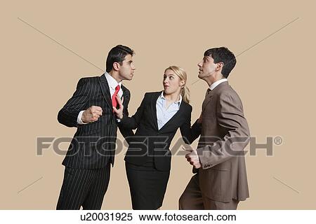 Stock Photography - Furious businessmen in conflict with woman trying to resolve over colored background. Fotosearch
