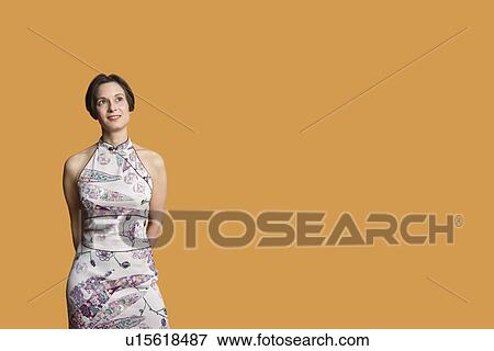 Happy mid adult woman standing over colored background View Large Photo Image Stock Photo - Happy mid adult woman standing over colored background. Fotosearch