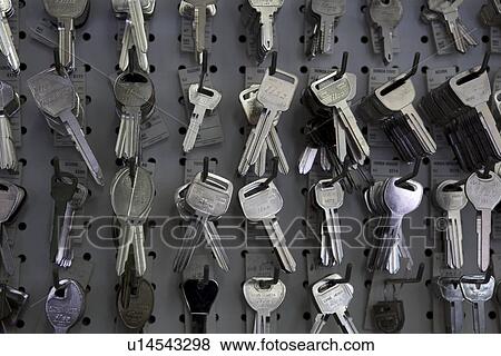 Keys hanging on hooks in store View Large Photo Image Stock Photo - Keys hanging on hooks in store. Fotosearch