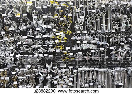 Stock Image - Large group of metallic equipments on display in hardware store. Fotosearch