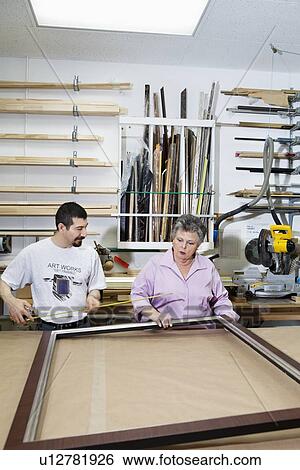 Mature employee measuring picture frame with senior owner in workshop View Large Photo Image Stock Photograph - Mature employee measuring picture frame with senior owner in workshop. Fotosearch