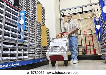 Mature man pushing handtruck in hardware store View Large Photo Image Stock Photograph - Mature man pushing handtruck in hardware store. Fotosearch