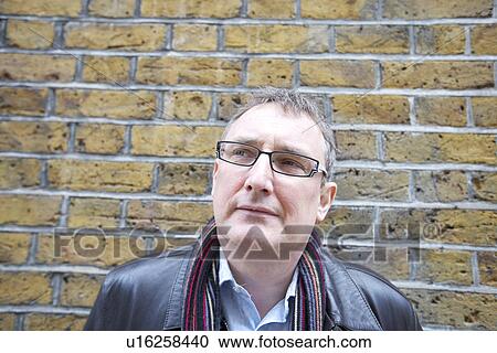 Stock Image - Mature man wearing glasses looking away. Fotosearch