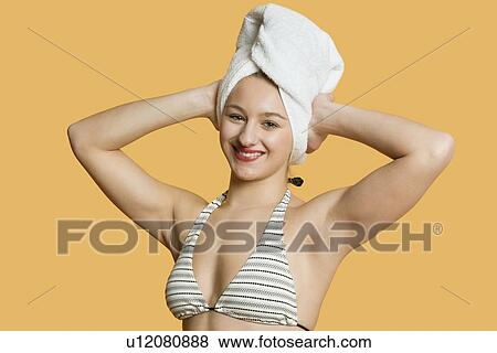 Stock Photo - Portrait of a beautiful woman with towel on head. Fotosearch