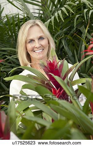 Portrait of a cheerful senior woman in garden center View Large Photo Image Stock Image - Portrait of a cheerful senior woman in garden center. Fotosearch