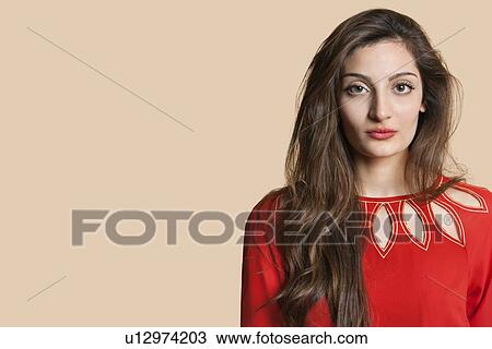Portrait of a confident young woman in red over colored background View Large Photo Image Stock Image - Portrait of a confident young woman in red over colored background. Fotosearch