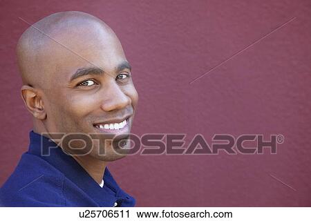 Portrait of a happy African American man over colored background View Large Photo Image Stock Image - Portrait of a happy African American man over colored background. Fotosearch