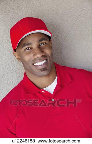 Portrait of a happy African American against wall View Large Photo Image Stock Photo - Portrait of a happy African American against wall. Fotosearch