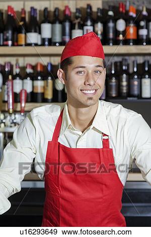 Stock Photo - Portrait of a happy bartender in bar. Fotosearch