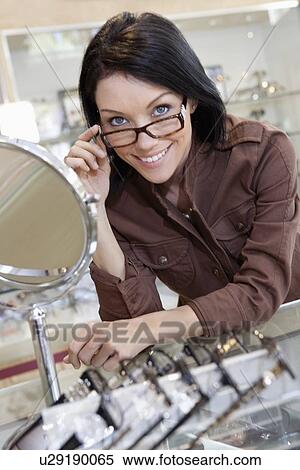 Stock Photography - Portrait of a happy beautiful mid adult woman wearing glasses. Fotosearch
