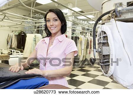 Portrait of a happy mid adult woman in laundry View Large Photo Image Stock Image - Portrait of a happy mid adult woman in laundry. Fotosearch