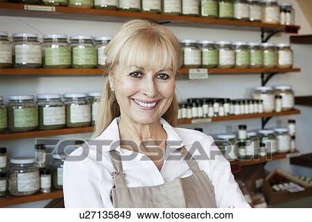Portrait of a happy senior female employee in spice store View Large Photo Image Stock Photo - Portrait of a happy senior female employee in spice store. Fotosearch