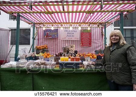 Portrait of a happy senior fruit stall owner standing in market View Large Photo Image Stock Image - Portrait of a happy senior fruit stall owner standing in market. Fotosearch