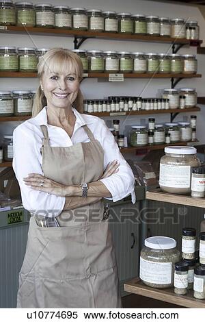 Portrait of a happy senior woman with arms crossed in spice store View Large Photo Image Stock Photography - Portrait of a happy senior woman with arms crossed in spice store. Fotosearch