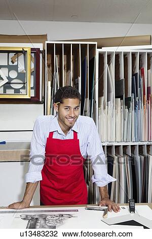 Stock Image - Portrait of a happy skilled worker in workshop. Fotosearch