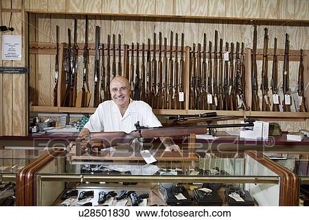 Portrait of a happy weapon shop owner View Large Photo Image Stock Image - Portrait of a happy weapon shop owner. Fotosearch