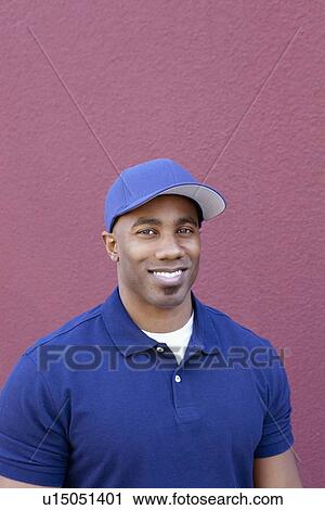 Portrait of a happy young African American man over colored background View Large Photo Image Stock Image - Portrait of a happy young African American man over colored background. Fotosearch